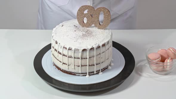 Chef Finishing a Birthday Cake Assembly By Placing a Rose As Decoration Final Decoration