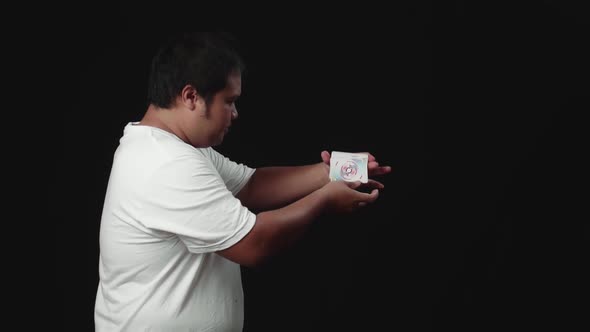Asian Magician Starts Showing His Trick With Cards, Cards Cascading Down