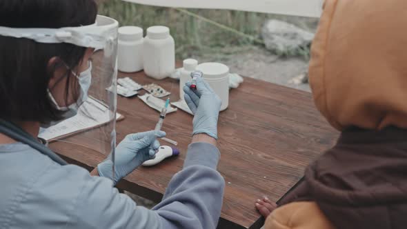 Little Refugee Girl Gets Vaccinated at Tent City