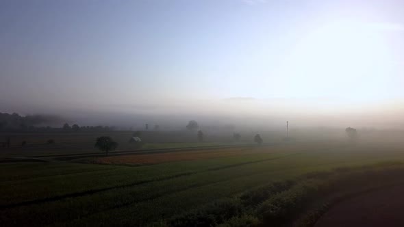 Tuscany Italy countryside in the morning with heavy fog, Aerial drone pan-right reveal shot