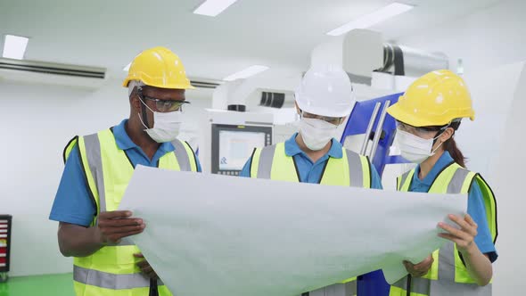 Group of interracial worker people wearing protective face mask while work in production factory.