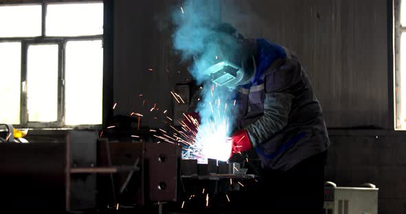 Industrial welder welding metal profiles