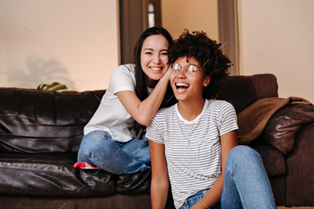 faces are resting and having fun sitting on a big sofa
