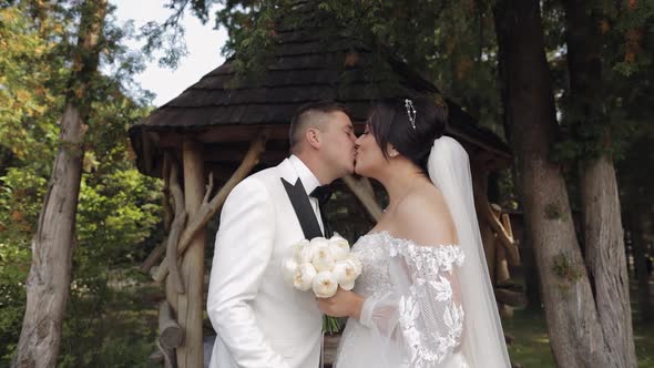 Newlyweds Caucasian Groom with Bride Walking Embracing Hugs in Park Wedding Couple in Love