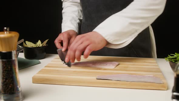 Professional Chef Cutting Raw White Fish Closeup Thin Slices