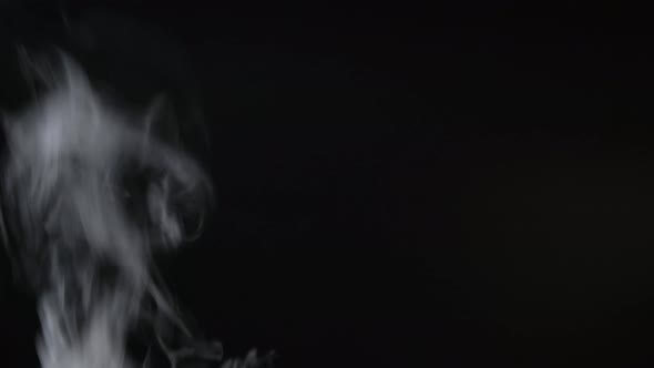 White smoke, fog, mist, vapor on a black background.