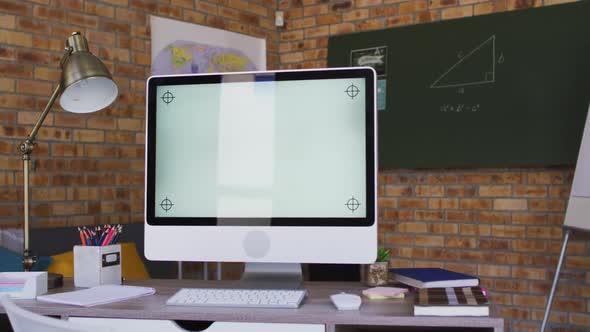 View of computer and other school supplies on table in the classroom at school