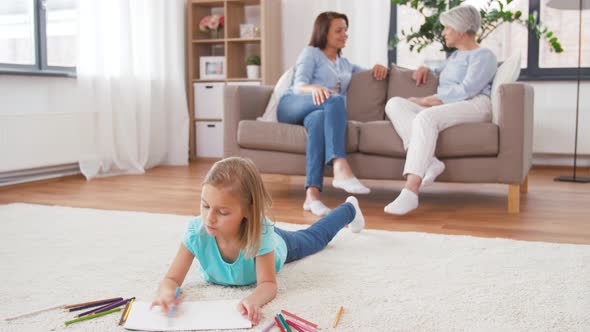 Adults Talking and Girl Drawing at Home 