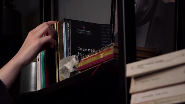 Woman Choose Books on Shelf.