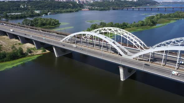 Panorama of the Darnitsky Bridge Across the River Dnipro in the Afternoon in Sunny Weather 