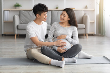 Happy asian man touching his pregnant wife big belly / Photodune, Misc