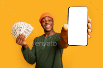 ank White Screen And Holding Dollar Money Cash, Recommending Online Casino Or New Mobile App, Standing Isolated Over Yellow Background, Mockup