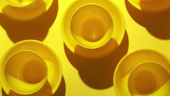 Yellow Plastic Bowls Are Placed in Layers for Background Texture.