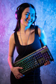 Beautiful Friendly Pro Gamer Streamer Girl Posing With a Keyboard in Her Hands, Wearing Glasses - PhotoDune Item for Sale