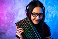 Young teen gamer wearing glasses standing posing with computer gaming equipment - PhotoDune Item for Sale