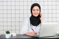 Muslim Female Doctor at her desk. White Background - PhotoDune Item for Sale
