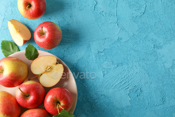 Apples and plate on blue background, space for text / Photodune, Misc