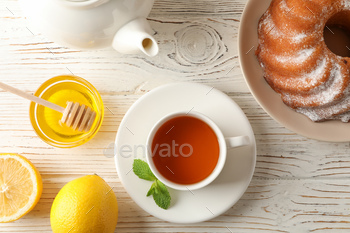 Cup of tea, lemon, mint, honey, dipper and pie on wooden background, top view / Photodune, Misc