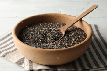 Wooden bowl with chia and spoon on white wooden background, space for text / Photodune, Misc