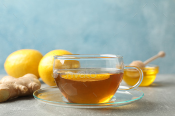 Cup of tea, lemon, honey and ginger on grey background, space for text / Photodune, Misc