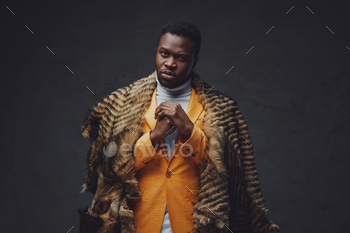 Aggressive african guy with fur isolated in dark background / Photodune, Misc