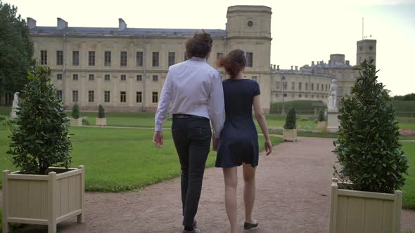 A Young Couple Walks in the Park.