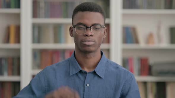 Young African Man Showing Thumbs Down Gesture