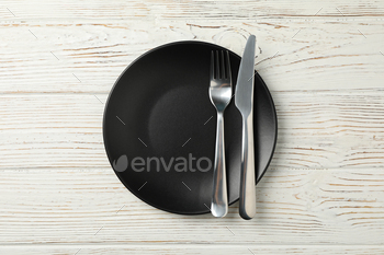 Plate with fork and knife on wooden background, top view / Photodune, Misc