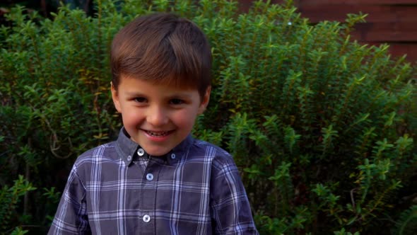 Smiling Boy Is Playing Outdoors