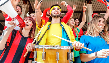ll cup match at intenational stadium bleachers – Sport concept with young people group with multicolor t-shirts having excited fun world championship