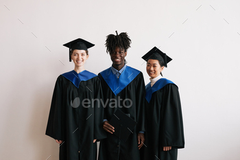 Smiling Young People Wearing Graduation Robes / Photodune, Misc
