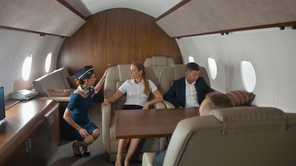 Pretty Stewardess Offers Help and Service for Luxury Private Jet Clients