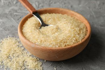 Bowl with rice and spoon on grey background, close up / Photodune, Misc