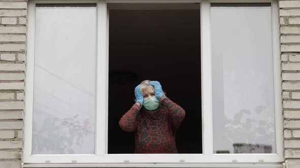 Old Woman Grandmother Stay at Window Isolated at Home on Quarantine. Coronavirus