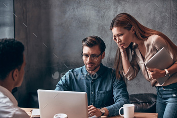 Group of young people in smart casual wear discussing business while working in the office / Photodune, Misc
