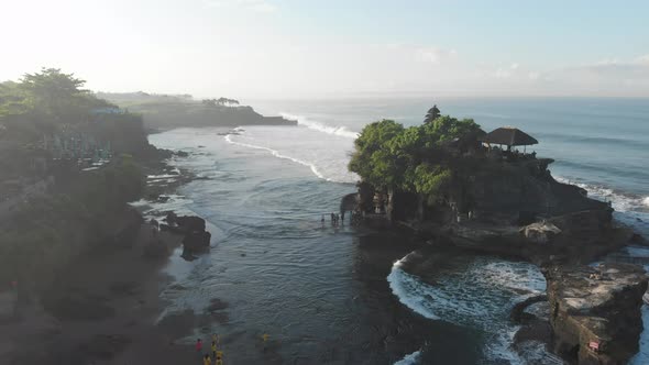 Aerial pan right past a Temple into open ocean