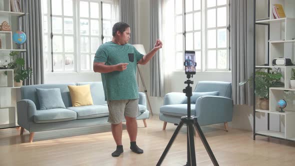 Man Blogger Shoots Video Content For Social Networks By Smartphone Camera, Magician With Red Ball