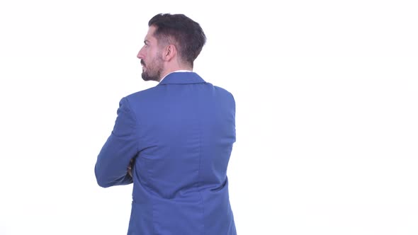 Rear View of Young Bearded Businessman Thinking and Waiting