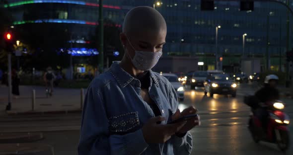 Girl with short shaved hair walking in the evening