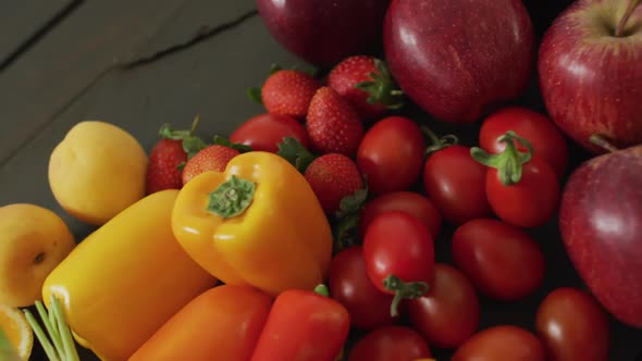 Video of fresh colourful fruit and vegetables on wooden boards in background