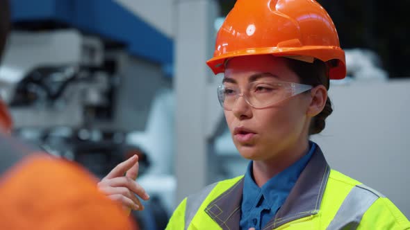 Woman Engineer Talking Unrecognizable Colleague Closeup