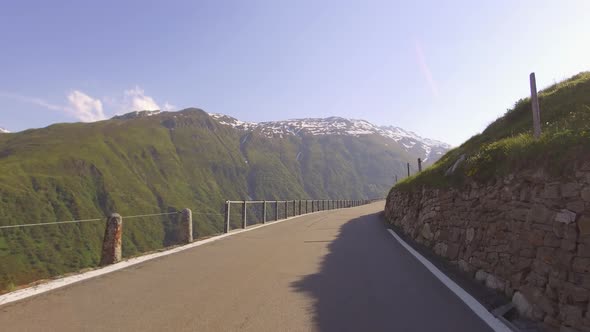 Driving on panoramic road through Swiss Alps. First Person POV