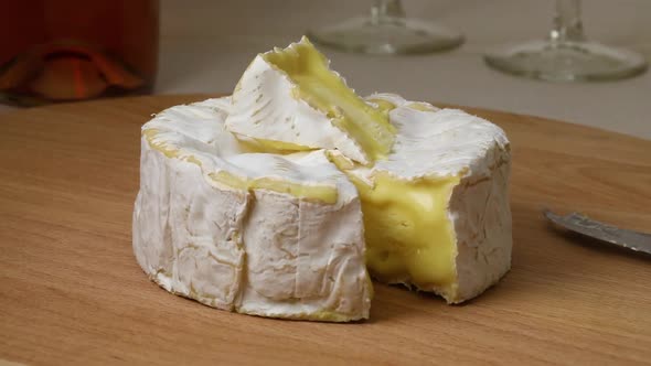 Mature camembert cheese and a piece close up 
