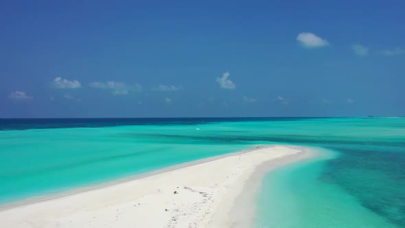 Aerial flying over seascape of luxury tourist beach wildlife by turquoise sea and white sand backgro