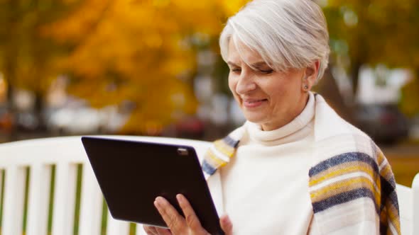 Senior Woman with Tablet Pc at Autumn Park 34