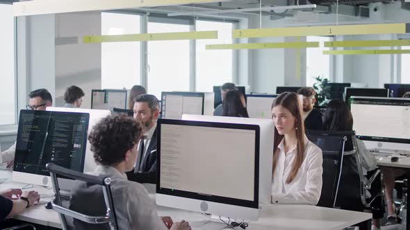 Modern Open Space Corporate Office with Tow Rows Off Businessmen and Businesswomen Working on