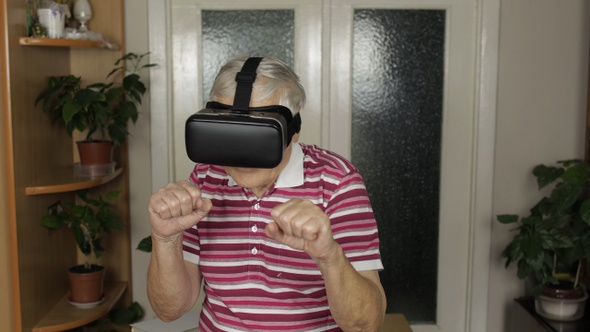 Grandmother in Virtual Headset Glasses Watching Video in VR Helmet Training Box, Shows Fist Fight