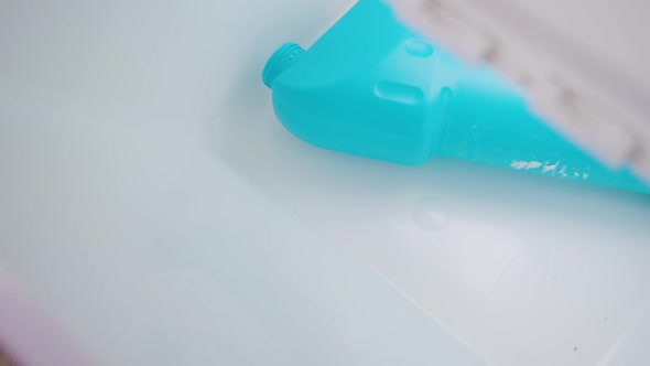 Woman Putting Plastic Bottles in a Box