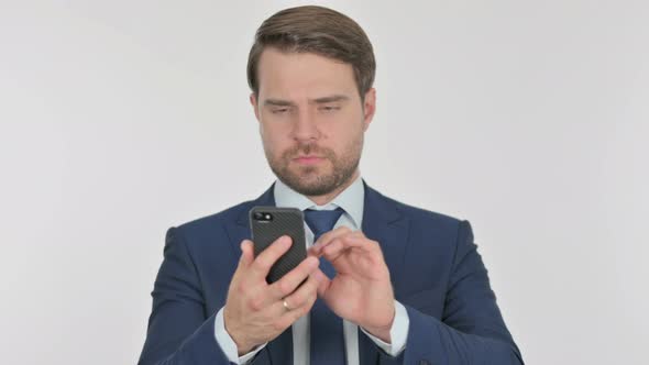 Young Businessman Browsing Smartphone on White Background