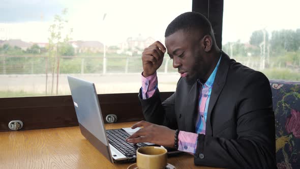 Black Man Works on Laptop but It's Broken and He Nervous and Knocking on Keys